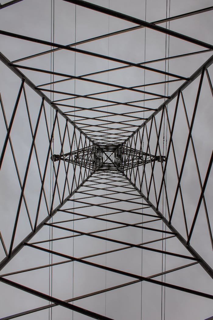 Abstract perspective of steel transmission tower from below.